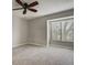 A cozy bedroom with a ceiling fan, neutral walls, and large window at 218 Wright St # 303, Lakewood, CO 80228