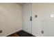 Image of the white front door with a black mat on hardwood floors at 218 Wright St # 303, Lakewood, CO 80228