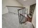 Loft view of the staircase leading down to the living room with a stone fireplace at 218 Wright St # 303, Lakewood, CO 80228