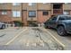 Apartment building with parking spaces and parking space number; brick and siding exterior at 218 Wright St # 303, Lakewood, CO 80228