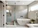 Spa-like bathroom with soaking tub and walk-in shower at 2664 S Cherokee St, Denver, CO 80223