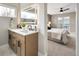 Double vanity bathroom with a view into the bedroom at 2664 S Cherokee St, Denver, CO 80223