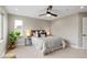 Well-lit bedroom with a ceiling fan and large window at 2664 S Cherokee St, Denver, CO 80223