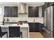 Modern kitchen with dark cabinetry and stainless steel appliances at 2664 S Cherokee St, Denver, CO 80223