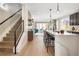 Modern kitchen with island and open layout to living area at 2664 S Cherokee St, Denver, CO 80223