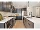 Modern kitchen with dark cabinetry, quartz countertops, and stainless steel appliances at 2664 S Cherokee St, Denver, CO 80223