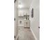 Bright laundry room with white cabinets and hexagon tile floor at 2664 S Cherokee St, Denver, CO 80223