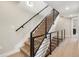 Modern staircase with wood steps and a black metal railing at 2664 S Cherokee St, Denver, CO 80223