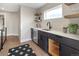 Stylish wet bar featuring dark cabinetry and a quartz countertop at 2664 S Cherokee St, Denver, CO 80223