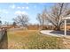 Large backyard featuring a well-maintained lawn, a concrete patio, and mature trees for shade at 8235 Auburn Ln, Westminster, CO 80031