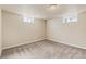 Basement bedroom with two windows and neutral carpeting at 8235 Auburn Ln, Westminster, CO 80031