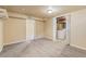 Unfinished basement with laundry area and open door at 8235 Auburn Ln, Westminster, CO 80031