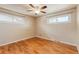 Bright bedroom featuring hardwood floors and multiple windows at 8235 Auburn Ln, Westminster, CO 80031