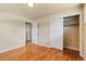 Bedroom with hardwood floors, closet and entry to hall at 8235 Auburn Ln, Westminster, CO 80031