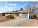 A single story home with solar panels, brick and vinyl siding, garage and a low maintenace yard at 8235 Auburn Ln, Westminster, CO 80031