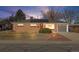 Charming brick home featuring a well-manicured front yard, single car garage, and solar panels at 8235 Auburn Ln, Westminster, CO 80031