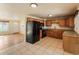 Eat-in kitchen features tile floors, wooden cabinets, stone countertops and black appliances at 8235 Auburn Ln, Westminster, CO 80031