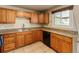 Eat-in kitchen features tile floors, wooden cabinets, stone countertops and black appliances at 8235 Auburn Ln, Westminster, CO 80031