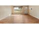 Bright living room showcasing gleaming hardwood floors and a large window with natural light at 8235 Auburn Ln, Westminster, CO 80031