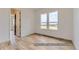 Well-lit bedroom with hardwood floors and access to hallway at 9719 Canyon Wind Pt, Parker, CO 80138