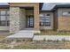 Front entry with stone accents and a modern door design at 9719 Canyon Wind Pt, Parker, CO 80138