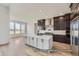 Modern kitchen with island and stainless steel appliances at 9719 Canyon Wind Pt, Parker, CO 80138