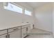 Laundry room with white cabinets and quartz countertop at 9719 Canyon Wind Pt, Parker, CO 80138