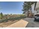 Spacious backyard featuring a patio, lawn and mature tree, offering ample space for outdoor living at 15531 E Jewell Pl, Aurora, CO 80013