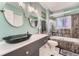Stylish bathroom with vessel sink, decorative mirrors, and modern fixtures at 15531 E Jewell Pl, Aurora, CO 80013