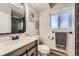 Stylish bathroom featuring a wood vanity, framed mirror, and updated fixtures, offering modern convenience at 15531 E Jewell Pl, Aurora, CO 80013