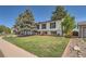 Two-story home featuring a well-maintained lawn, mature trees, and easy access to backyard at 15531 E Jewell Pl, Aurora, CO 80013