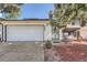 Welcoming front entrance with a paved walkway, cozy porch swing, and a two-car garage at 15531 E Jewell Pl, Aurora, CO 80013