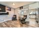 Cozy seating area with hardwood floors, comfortable armchairs, and a view into the kitchen at 15531 E Jewell Pl, Aurora, CO 80013