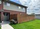 Charming townhouse with brick accents, a well-kept lawn, and a privacy fence, perfect for outdoor enjoyment at 8047 Wolff St # H, Westminster, CO 80031