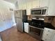 Efficient kitchen layout with stainless steel appliances, dark countertops and tiled backsplash, ideal for everyday cooking at 8047 Wolff St # H, Westminster, CO 80031