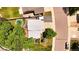 Aerial view of the home showcasing its roof, deck, outdoor seating area, and surrounding landscape at 8977 W Toller Ave, Littleton, CO 80128