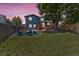Inviting backyard features a fire pit, seating, deck, and spacious lawn, perfect for outdoor enjoyment at 8977 W Toller Ave, Littleton, CO 80128
