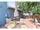 Cozy backyard deck area featuring outdoor dining table with umbrella and grill at 8977 W Toller Ave, Littleton, CO 80128