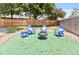 Backyard with outdoor seating area featuring four blue chairs, fire pit, and artificial turf at 8977 W Toller Ave, Littleton, CO 80128