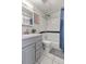 Well-lit bathroom includes a shower-tub combo and gray vanity at 8977 W Toller Ave, Littleton, CO 80128