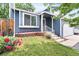 Charming home with a manicured lawn, a quaint flower bed, and a well-maintained exterior at 8977 W Toller Ave, Littleton, CO 80128
