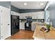 Well-lit kitchen with modern appliances, white cabinets, and butcher block countertops at 8977 W Toller Ave, Littleton, CO 80128