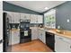 Well-lit kitchen featuring modern appliances, ample counter space, and stylish cabinetry at 8977 W Toller Ave, Littleton, CO 80128