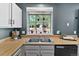 Kitchen features a stainless steel sink, wood countertops, and bright natural light at 8977 W Toller Ave, Littleton, CO 80128