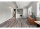 Basement laundry room with hardwood floors, gray walls, washer, dryer, and stairway at 8977 W Toller Ave, Littleton, CO 80128