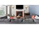 Inviting living room featuring a fireplace, a comfortable sofa, and large windows for ample natural light at 8977 W Toller Ave, Littleton, CO 80128