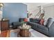 Spacious living room with a large sectional sofa, a wooden coffee table, and an open floor plan at 8977 W Toller Ave, Littleton, CO 80128