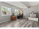 Bright office space with large windows, wood floors, and a stylish workstation at 8977 W Toller Ave, Littleton, CO 80128