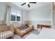 Cozy bedroom featuring a crib, toddler bed, neutral tones, and a bright window at 12063 Monaco Ct, Brighton, CO 80602