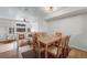 Bright dining room with a wooden table and six chairs, adjacent to a cozy living space at 12063 Monaco Ct, Brighton, CO 80602